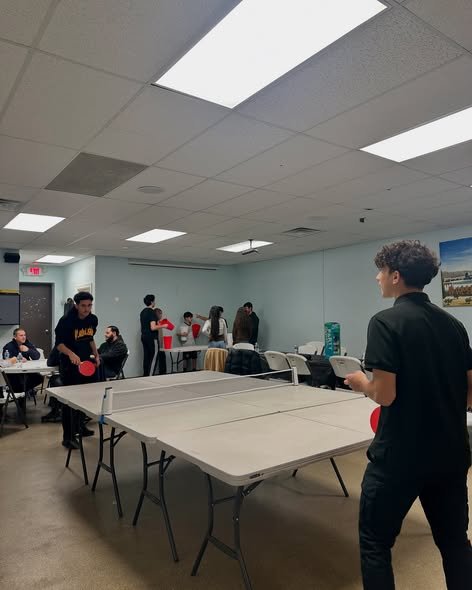 Community members playing table tennis inside Beit Anan Community Center